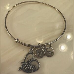 Alex and Ani “love” charm bangle bracelet!
Some tarnishing, but can be cleaned .